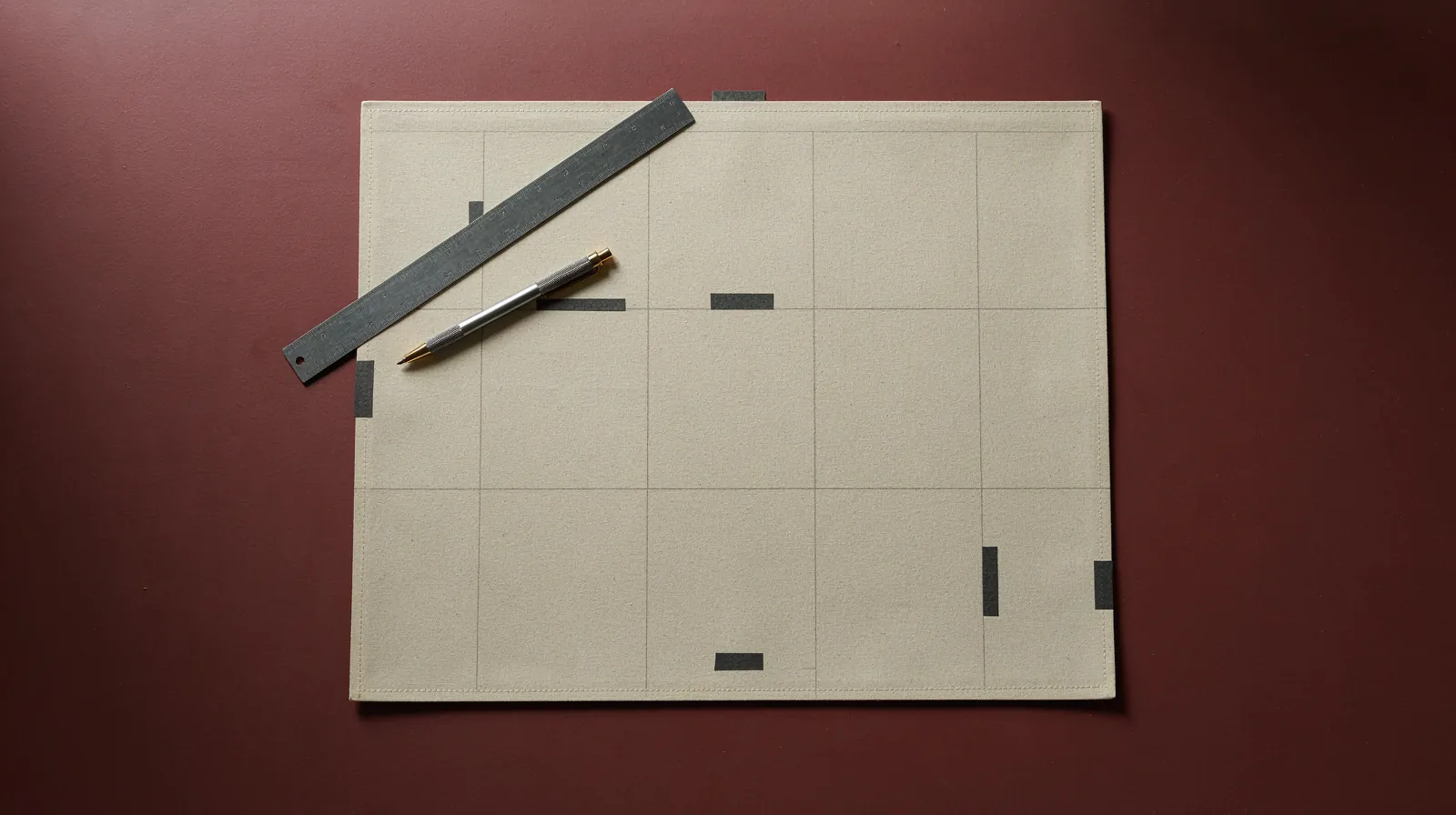 A nine-block business model canvas poster on a worktable with sticky notes marking a few blocks.